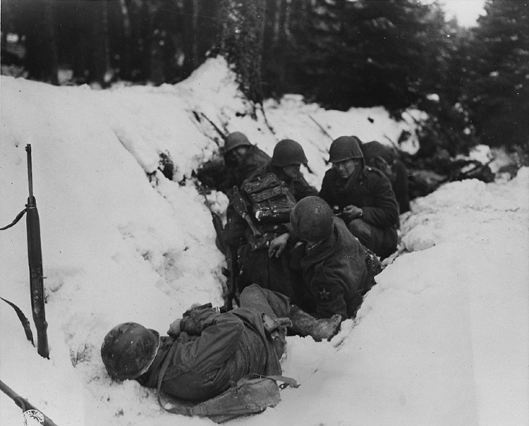 US soldiers take cover from German fire 14 December 1944